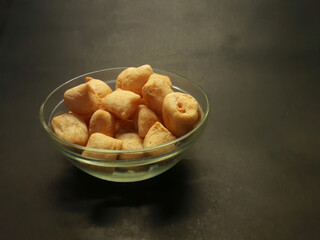 Tofu crispy in a glass bowl with black background