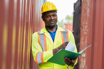 African American male container yard engineer worker repairing or maintaining container boxes...