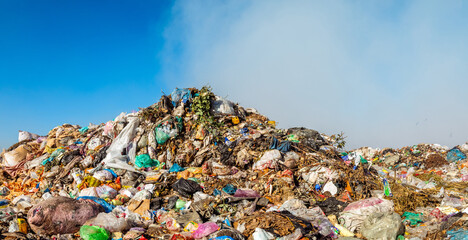 Closeup of burning trash piles in landfill - Powered by Adobe
