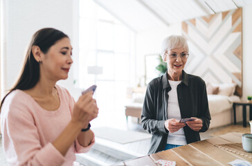 Elderly multiracial female friends spending time enjoying gambling