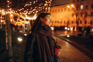 Happy woman at the Christmas market at night