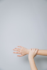 The man's hand holds his hand tightly. Compulsion. Violence to work. Day of the struggle for the abolition of slavery