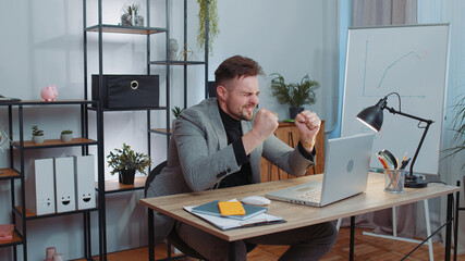 Businessman programmer software developer in suit working on laptop loses becoming surprised sudden...