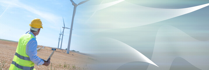 Engineer using laptop for wind turbine inspection; panoramic banner