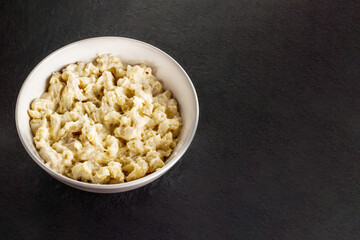Mac and cheese. Traditional american fast food. Pasta with sauce from chedder parmesan mozarella and other cheese.