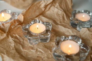 Candles burn in transparent candlesticks