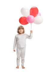 Fototapeta na wymiar Cute little girl in pajamas holding balloons
