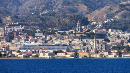 Fototapeta premium Downtown City by the Sea with mountain background. Messina, Sicilia, Italy. Sunny Morning.