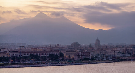 Fototapeta na wymiar City on Mediterranean Coast with mountains in background in Palermo, Sicily, Italy. Sunset Sky.