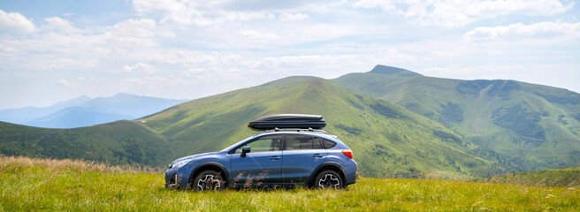 Blue off road car on mountain trail. Traveling by auto, adventure in wildlife, expedition or...