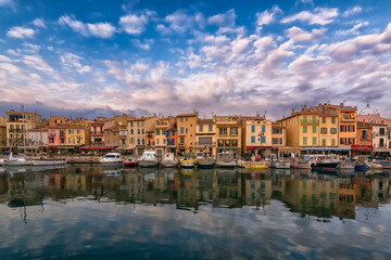Scenic view of small village of Cassis in south of France with mirror reflection to Mediterranean sea against dramatic sky