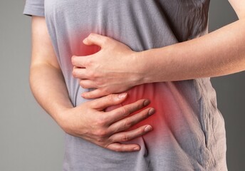 Stomachache and indigestion. Hands on inflammed belly abdomen with gastrointestinal disease,...