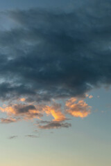 dark rain clouds backlit by the evening sun as a natural background