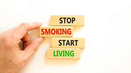 Stop smoking start living symbol. Concept words Stop smoking start living on cubes. Beautiful white background. Doctor hand. Medical healthy lifestyle stop smoking start living concept. Copy space.