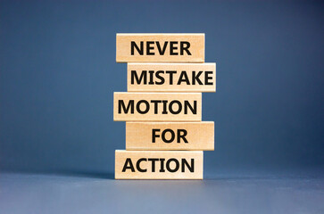 Mistake or action symbol. Concept words Never mistake motion for action on wooden blocks. Beautiful grey table grey background. Business mistake or action concept. Copy space.