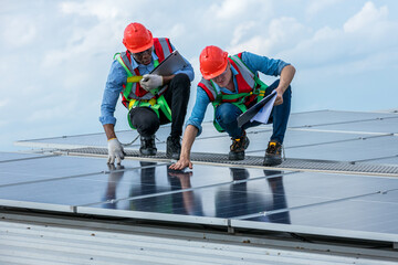 Engineer working setup Solar panel at the roof top. Engineer or worker work on solar panels or solar cells on the roof of business building	