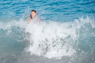 little girl swims in the sea on an inflatable ring. sea ​​waves. family vacation concept