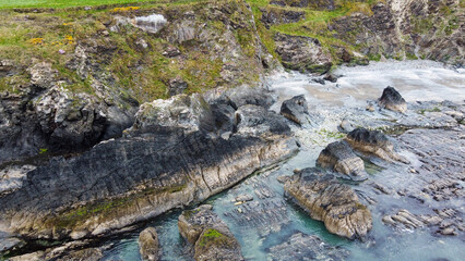Large stones on the seashore. The rocky coastline of Ireland. Beautiful nature of northern Europe. Drone point of view.