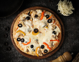Delicious pizza with a sophisticated background of cheese and vegetables