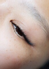 Fototapeta premium Close up of eyelash Extensions in beauty salon macro eye