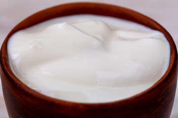 Fresh delicious sour cream in a bowl close up