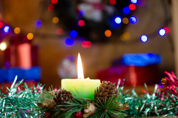 Close-up photo of candle shining on the  festive table among colourful decoration at wonderful Christmas Day