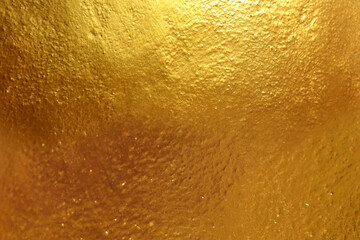 Background or brushed gold metallic surface.