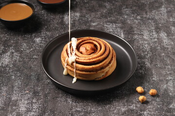 Delicious Cinnabon painted on a dark black background