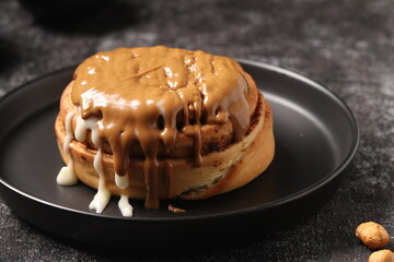 Delicious Cinnabon painted on a dark black background