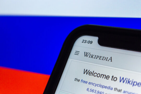 Vancouver, CANADA - Oct 19 2022 : Conceptual image Wikipedia website seen in iPhone screen on Russian Flag background. Website block and censorship in Russia Concept.
