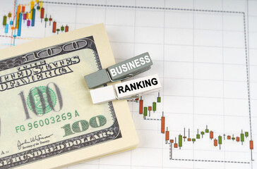 On the charts of quotations are dollars, clothespins with the inscription - BUSINESS RANKING