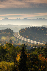 Highway towards the Tatra Mountains in autumn scenery with a view of the highest peaks in Poland.