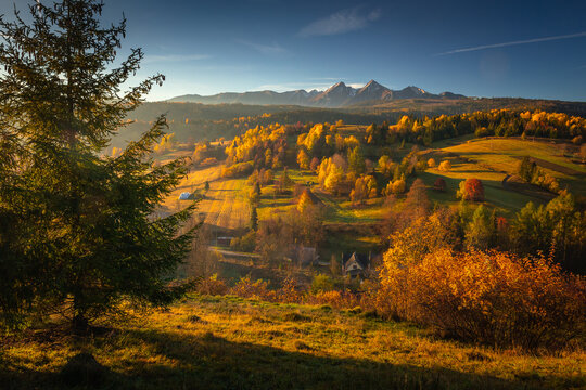 Highway towards the Tatra Mountains in autumn scenery with a view of the highest peaks in Poland.