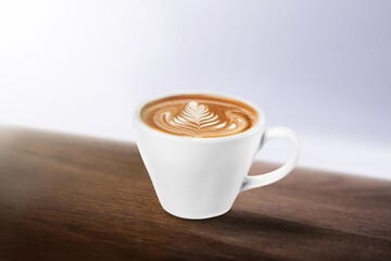 Cup of tasty sweet hot coffee on desk