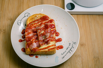 Cheesy Toasted topping with croissant and Parmesan Cheese and Ketchup