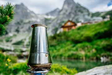 Metal teapot with coffee on a gas burner during a trip to the mountains