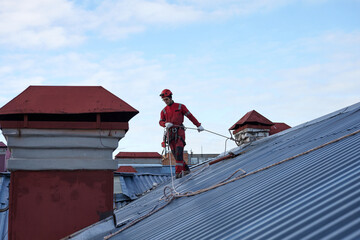 A specialist is repairing the roof. Rope access	