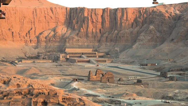 Drone shot over the Hatshepsut temple in Egypt with the mountain in the background, sunrise