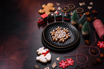 Fototapeta na wymiar Beautiful different Christmas decorations and gingerbread on a brown concrete table
