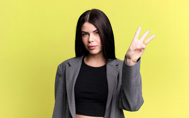 young adult pretty woman smiling and looking friendly, showing number three or third with hand...