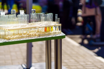 Chemical test tubes after use stand on a table in a stand