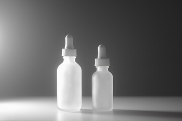 Two empty white translucent glass dropper vials beside each other on two-tone white background. Different-sized bottles in center. Dramatic side lighting. Horizontal beauty background and copy space.