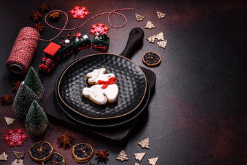 Beautiful different Christmas decorations and gingerbread on a brown concrete table