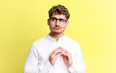 young adult caucasian man scheming and conspiring, thinking devious tricks and cheats, cunning and...