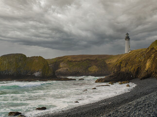 Majestic seascape. Dramatic sky with gray storm clouds, ocean and moss-covered mountain range on the shore. Desert place. Ecology, environmental protection, wildlife beauty.