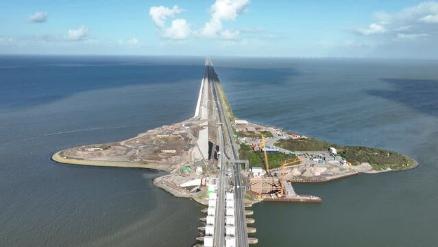 Afsluitdijk construction on pumping stations new sluices and the A7 near Den Oever, Kornwerderzand , and Zurich. Lock for shipping, road traffic cyclists and walkers. Aerial drone view.