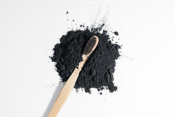 Concept of deep and detailed cleaning of the teeth. Black disclosing powder for bleaching. Dental whitening concept. Biodegradable toothbrush with soft bristle.