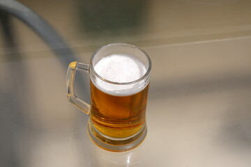 In a glass of fresh and cold beer.