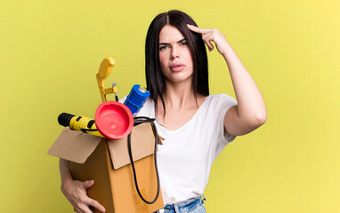 feeling confused and puzzled, showing you are insane. housekeeper with a toolbox