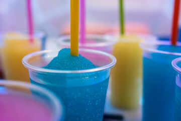 Granita Slush, a fruity chilled frappe drink in a plastic cup with a straw. Sweet refreshing dessert